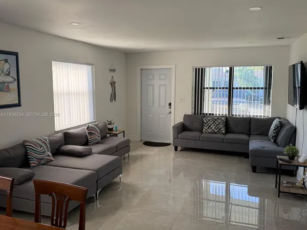 a living room with furniture and a window