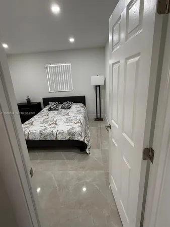 a bedroom with a bed and a mirror