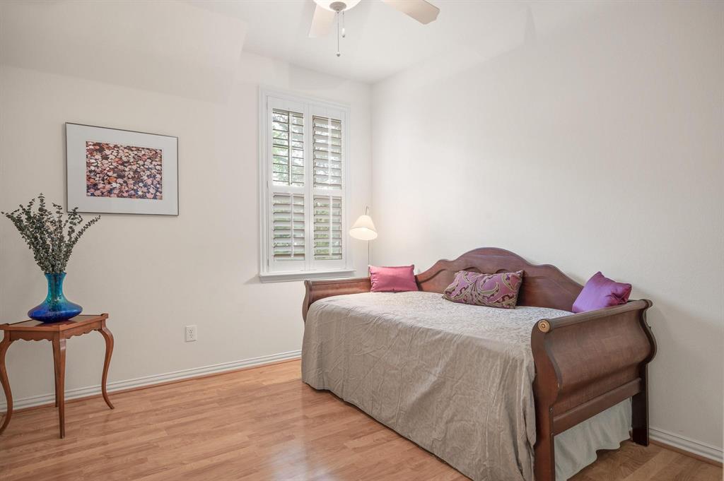 4209 Sexton Lane Dallas, TX 75229 - Photo 5 of 27 a bedroom with a bed and wooden floor