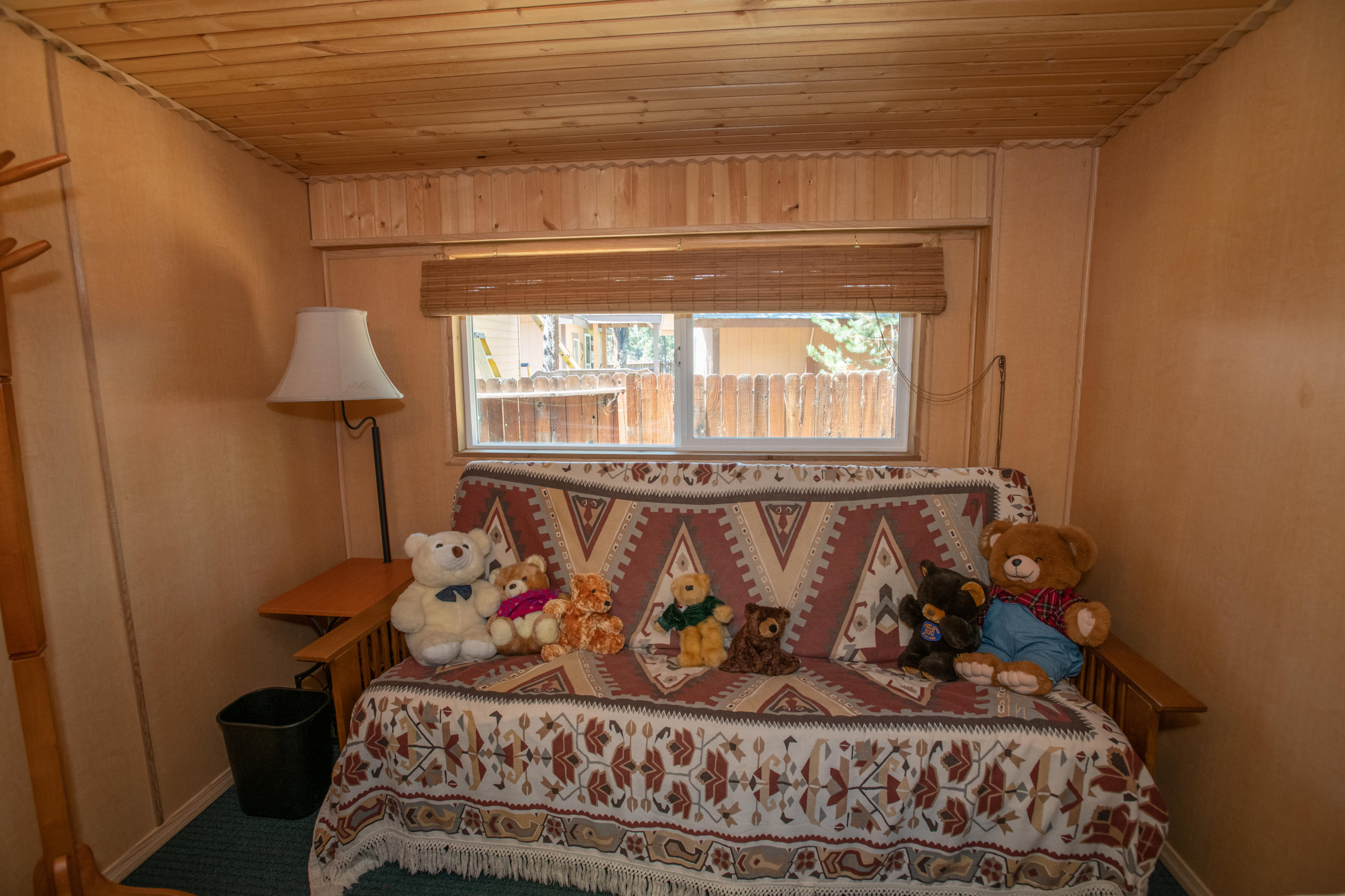 17031 Azusa Road Bend, OR 97707 - Photo 9 of 27 a bed sitting in a bedroom next to a window with a chandelier