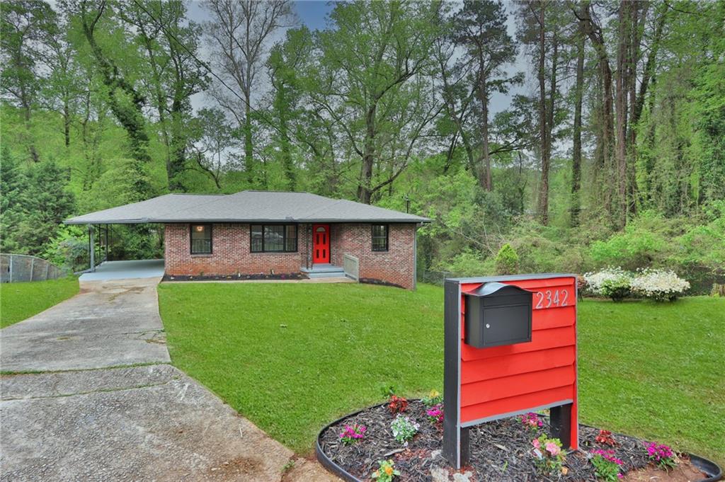 2342 Starline Drive Decatur, GA 30032 - Photo 1 of 1 a front view of a house with a yard table and chairs