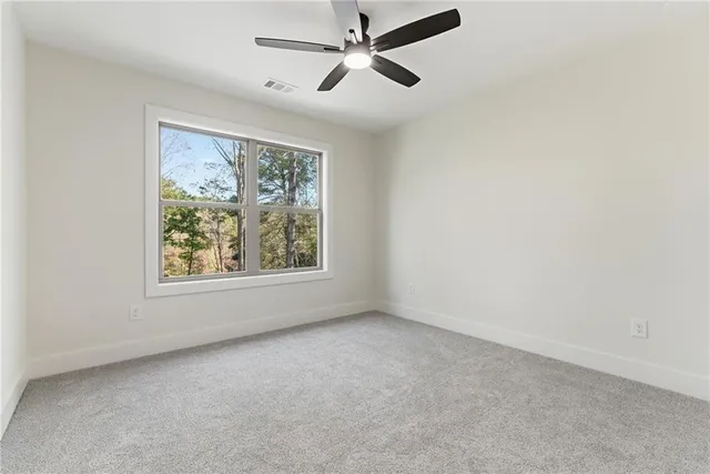 a view of a small house with backyard