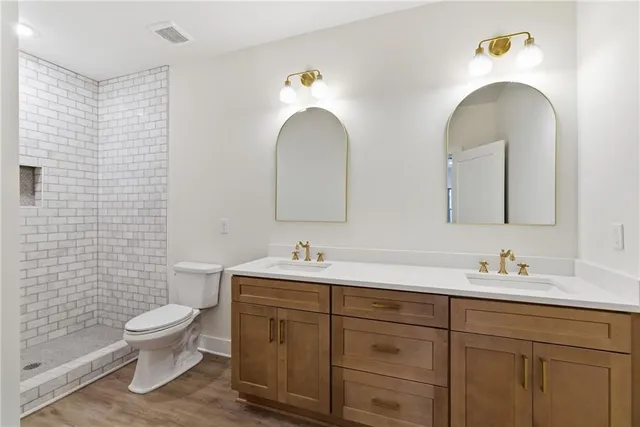 an aerial view of a house with a yard and trees all around