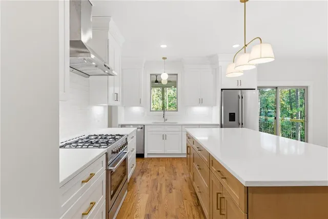 a kitchen with white cabinets and appliances