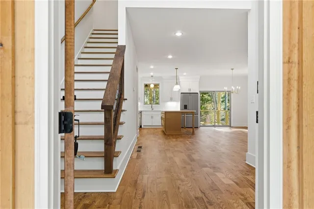 a view of an empty room with a fireplace and a window