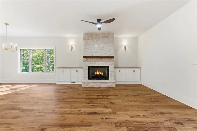 a large kitchen with kitchen island a large counter top stainless steel appliances and cabinets
