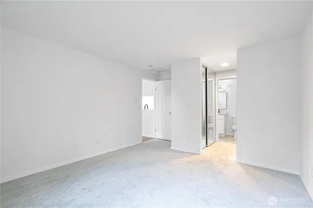 a bathroom with a granite countertop toilet a sink and shower