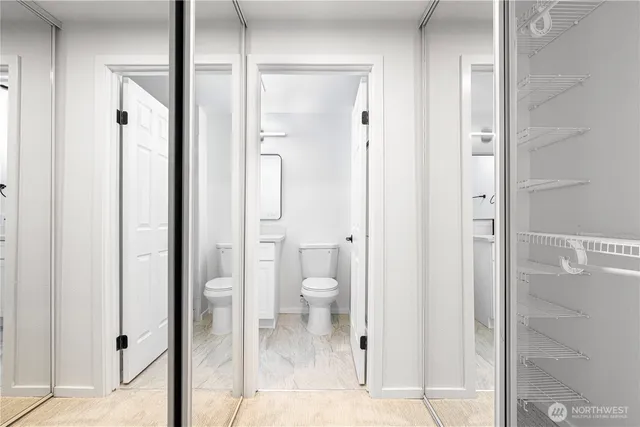 a bathroom with a toilet sink and mirror