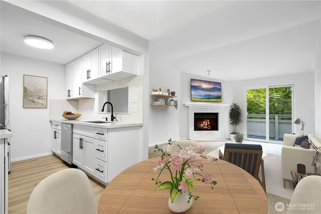 a living room with furniture fireplace and a large window