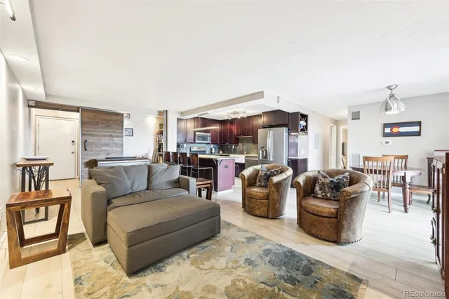 a living room with furniture ceiling fan and a rug