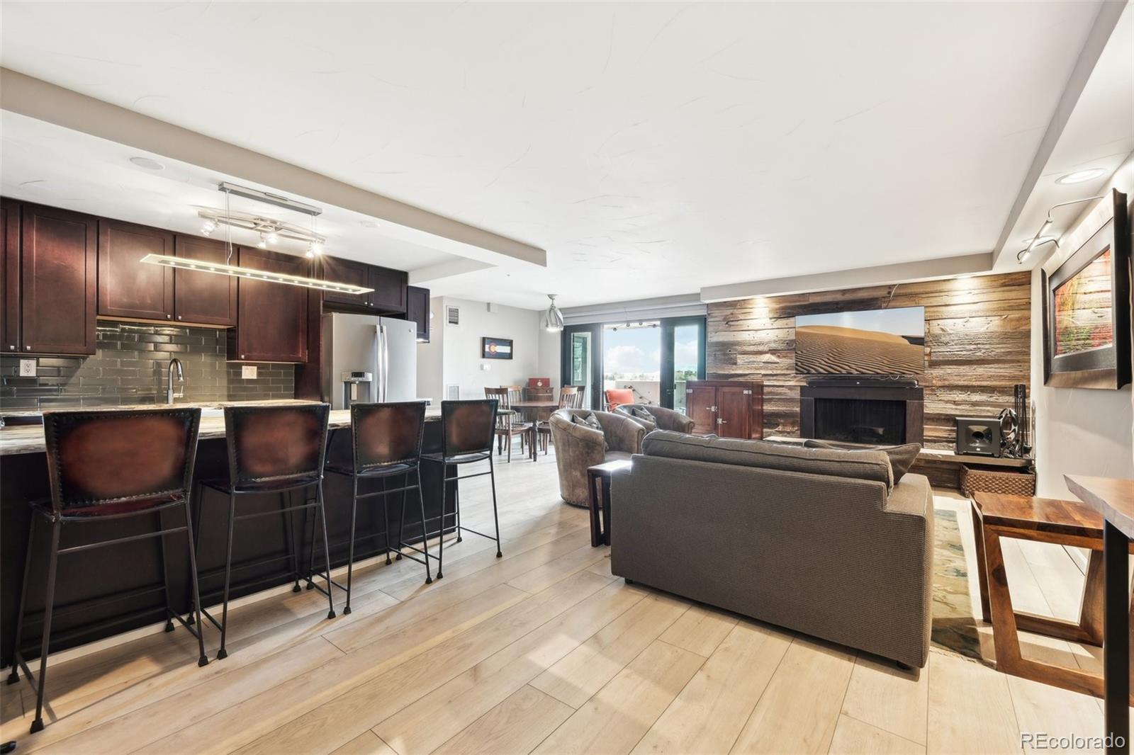 2 Adams Street, Unit 705 Denver, CO 80206 - Photo 11 of 50 a living room with furniture and a flat screen tv