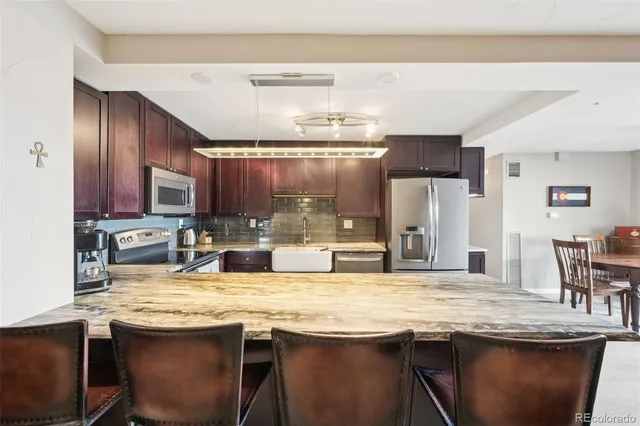 a kitchen with granite countertop a sink and wooden cabinets