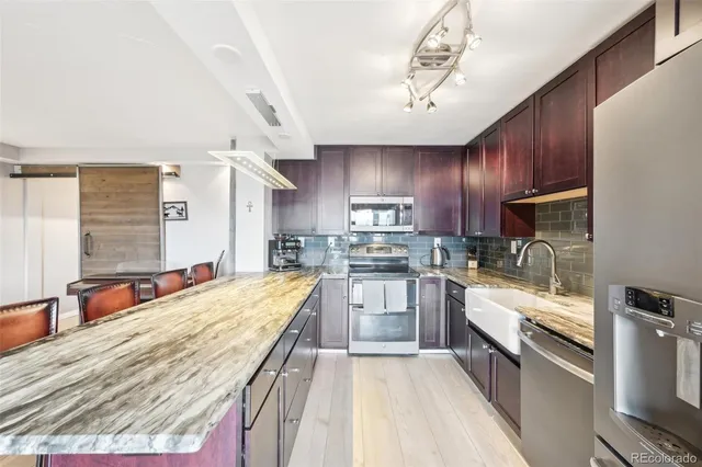 a large kitchen with stainless steel appliances kitchen island granite countertop a large counter top stainless steel appliances and cabinets