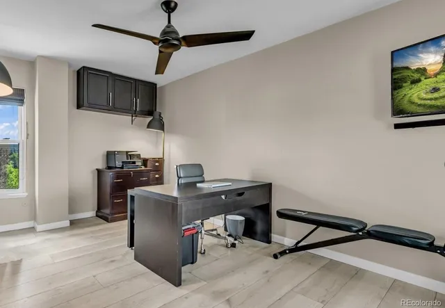 a view of a workspace with furniture and a flat screen tv