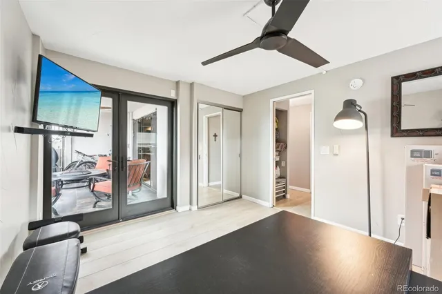 a view of a livingroom with wooden floor and a ceiling fan