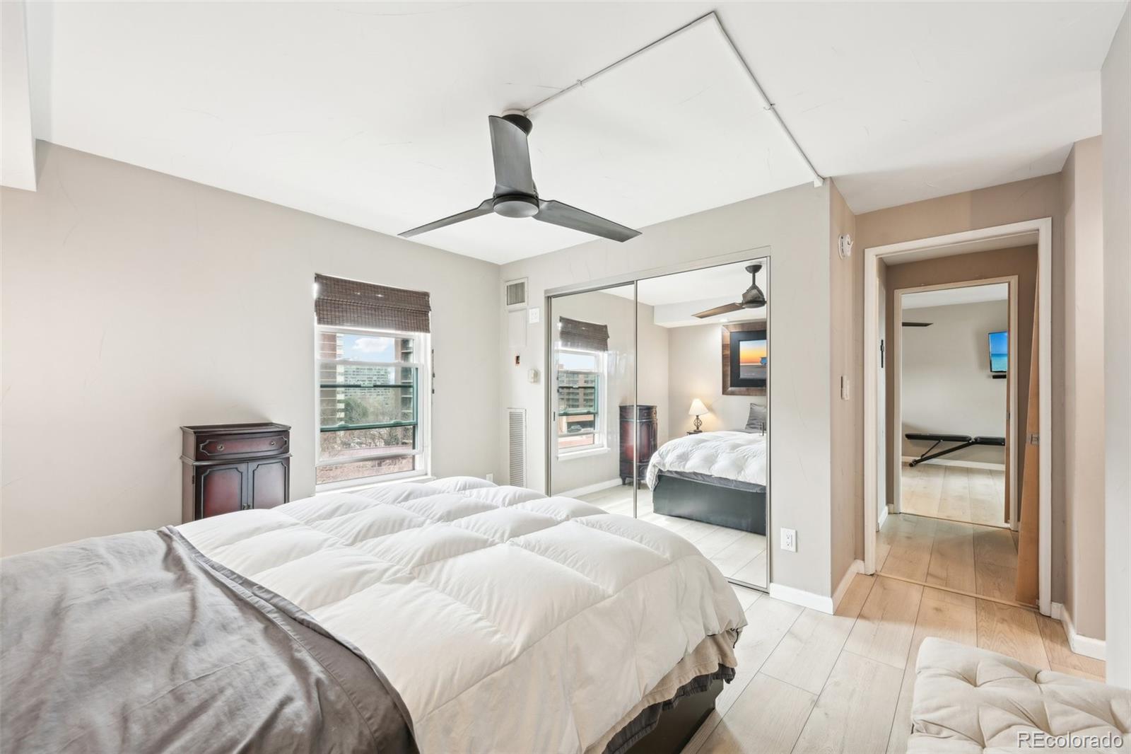 2 Adams Street, Unit 705 Denver, CO 80206 - Photo 28 of 50 a bedroom with a large bed and a chandelier