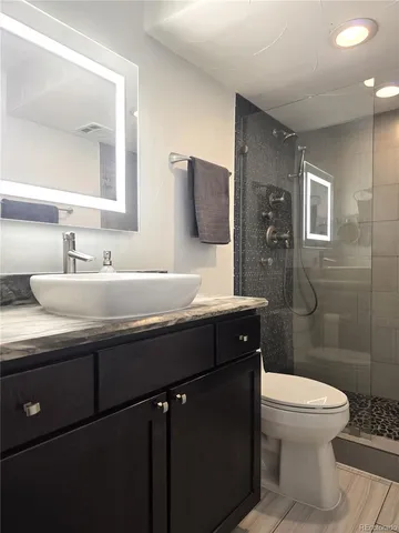 a bathroom with a sink toilet and shower