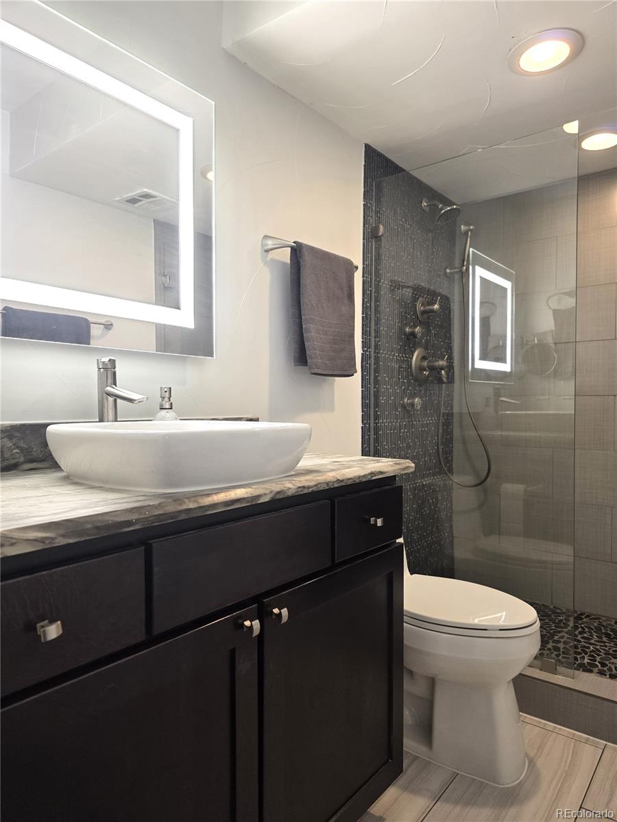 2 Adams Street, Unit 705 Denver, CO 80206 - Photo 31 of 50 a bathroom with a sink toilet and shower