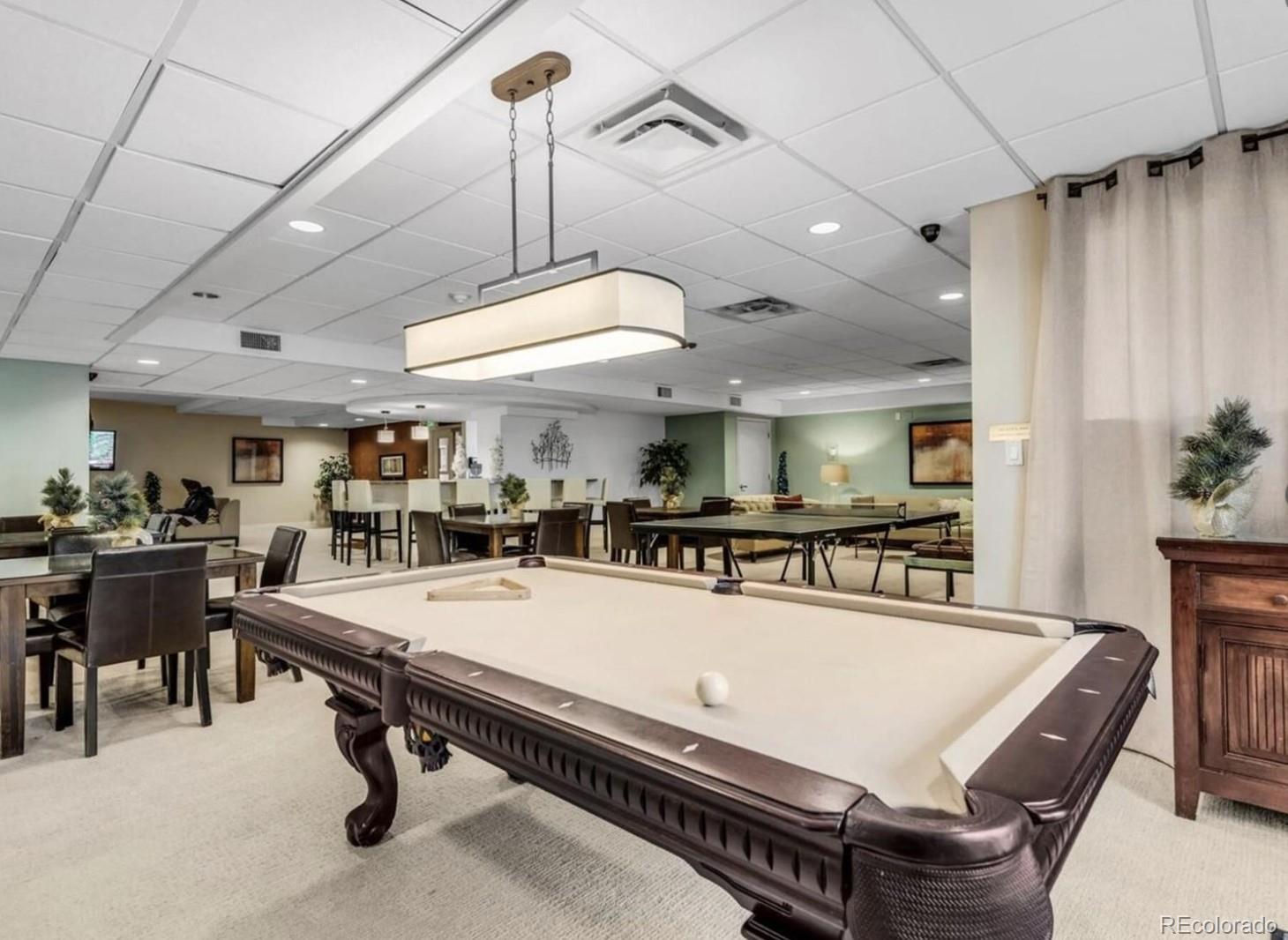 2 Adams Street, Unit 705 Denver, CO 80206 - Photo 48 of 50 a room with lots of furniture and a chandelier