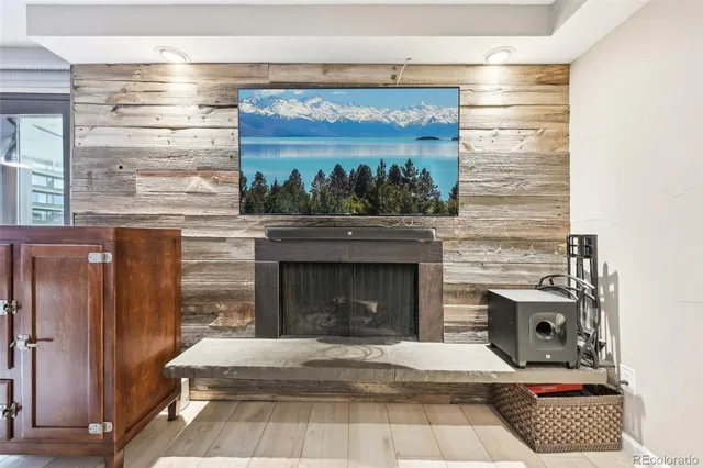a living room with a fireplace and a floor to ceiling window