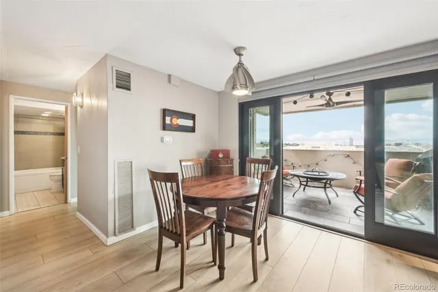 a view of a dining room with furniture large windows and wooden floor