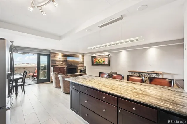 a bathroom with a granite countertop sink and a large mirror