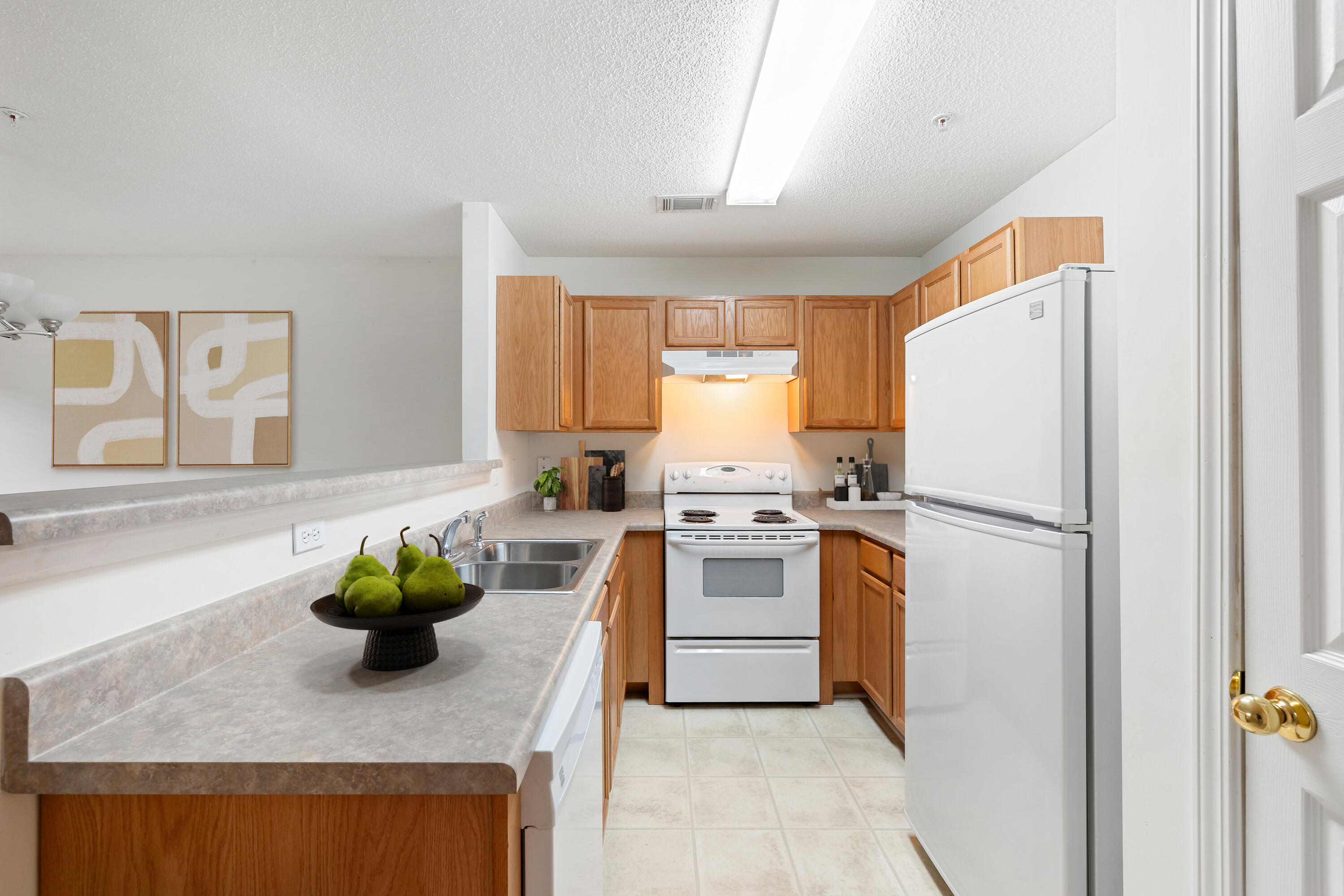 363 Crooked Pine Trail Crestview, FL 32539 - Photo 4 of 8 a white kitchen with a stove a refrigerator and a sink