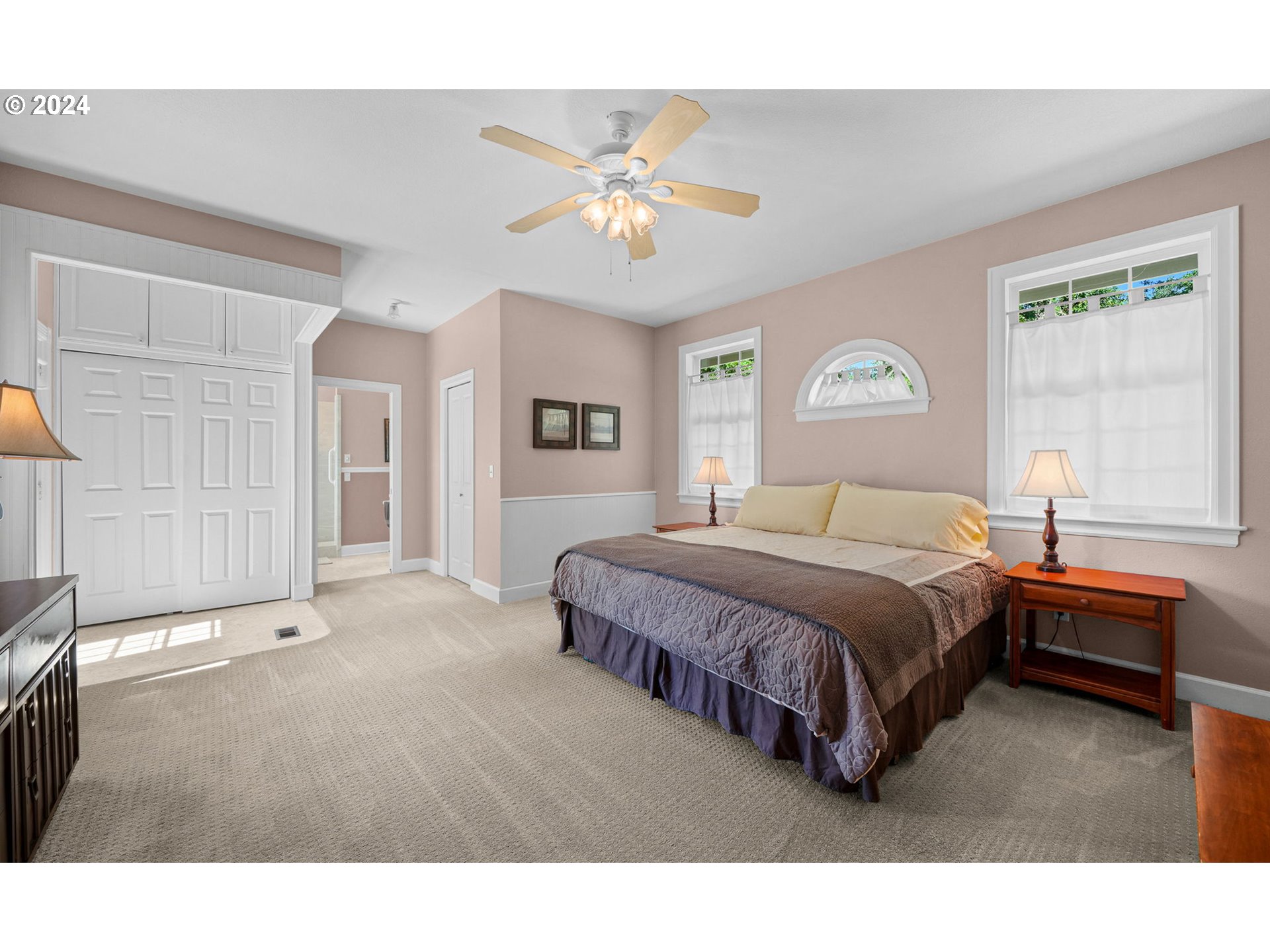 33482 Molitor Ranch Road Cottage Grove, OR 97424 - Photo 34 of 48 a spacious bedroom with a bed and a chandelier