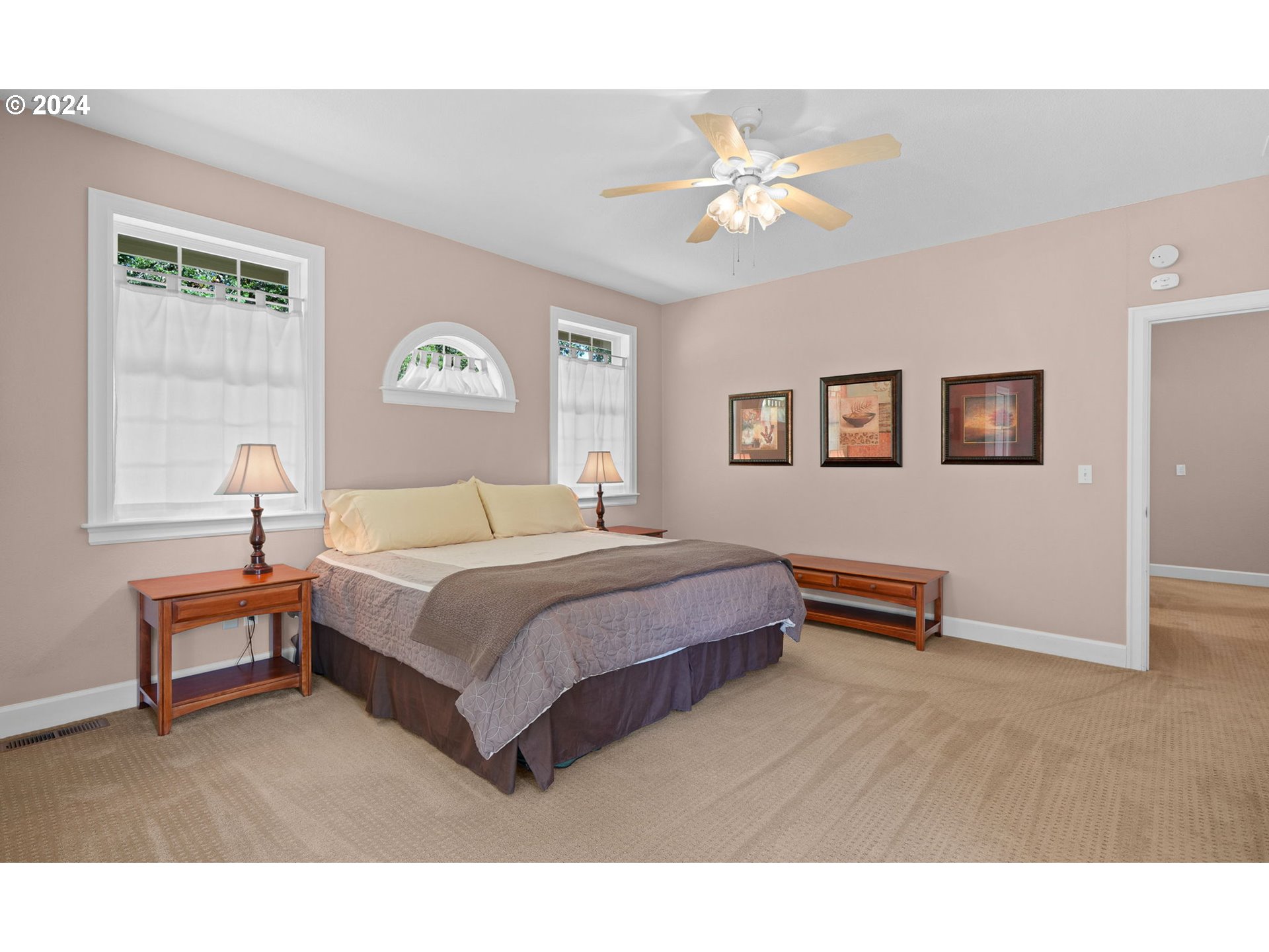 33482 Molitor Ranch Road Cottage Grove, OR 97424 - Photo 35 of 48 a spacious bedroom with a bed and a chandelier