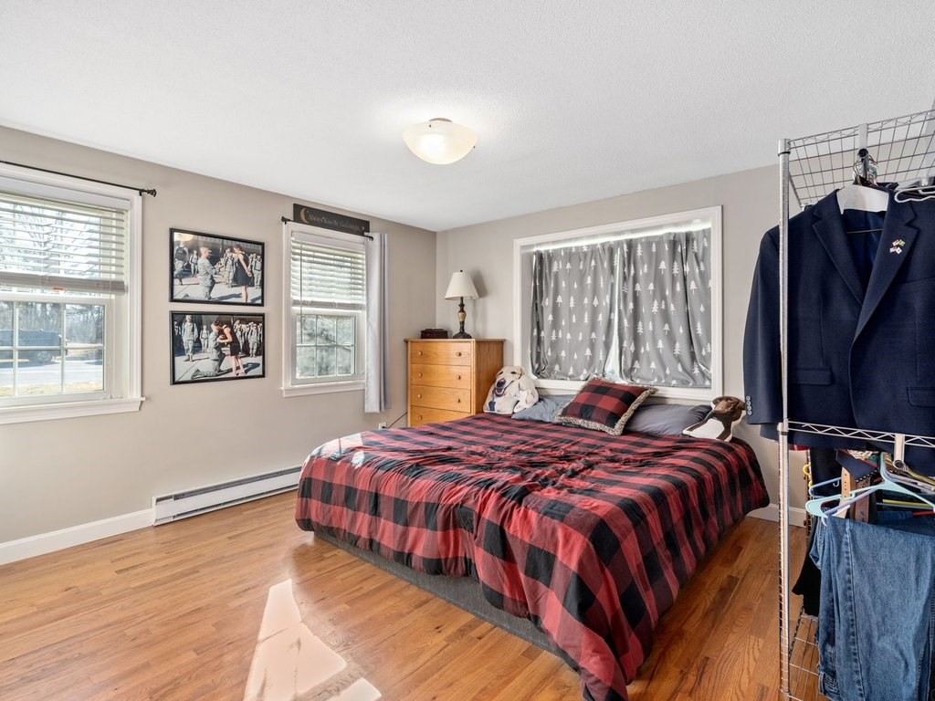 62 Middle Road Amesbury, MA 01913 - Photo 12 of 24 a bedroom with a bed and wooden floor