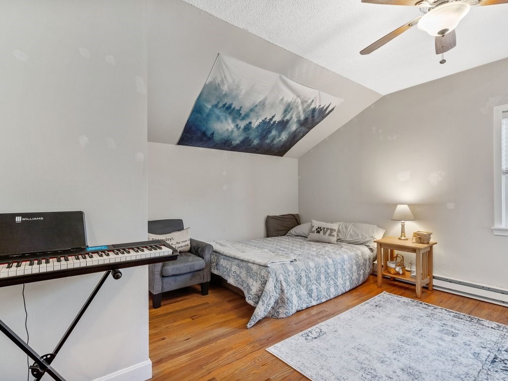 62 Middle Road Amesbury, MA 01913 - Photo 16 of 24 a bedroom with a bed and wooden floor