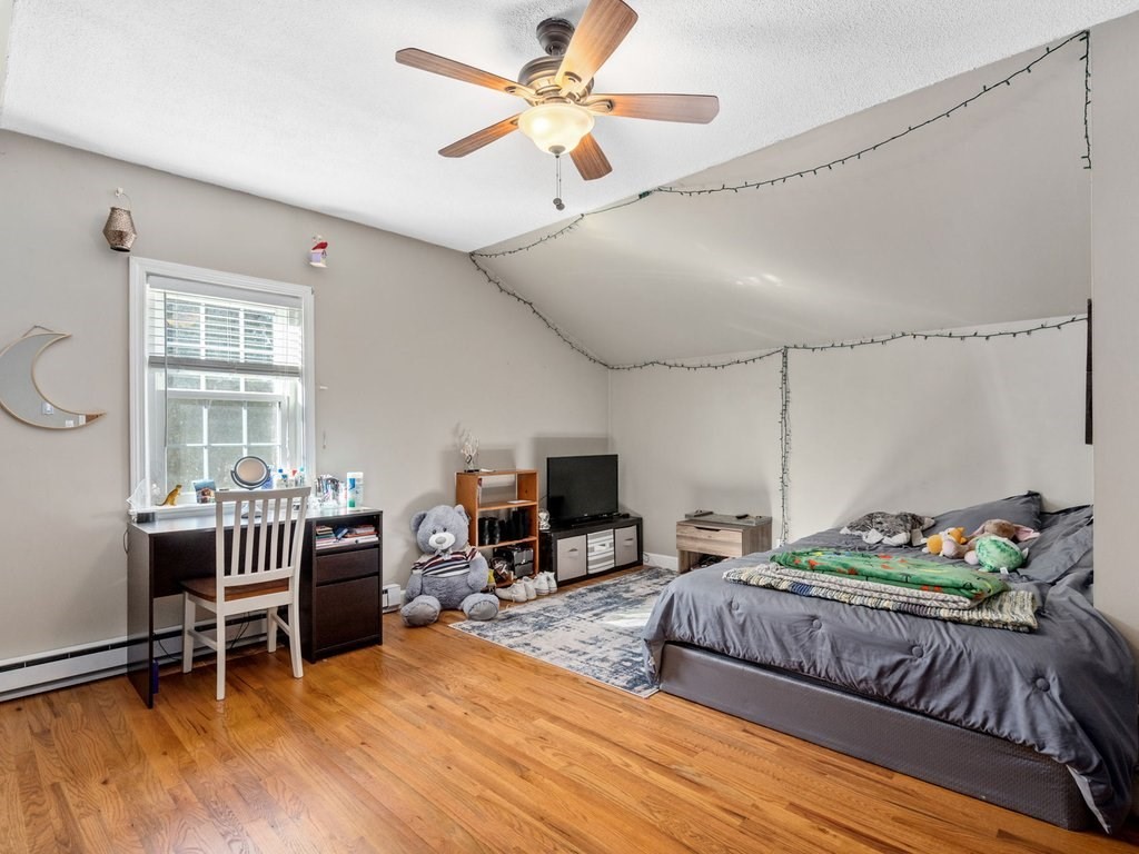 62 Middle Road Amesbury, MA 01913 - Photo 17 of 24 a bedroom with a bed and a chandelier