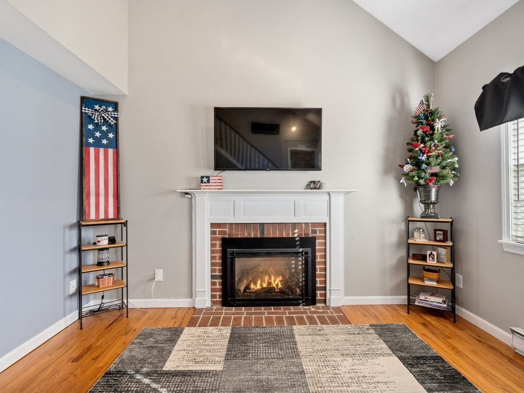 62 Middle Road Amesbury, MA 01913 - Photo 7 of 24 a living room with a bookshelf and a fireplace