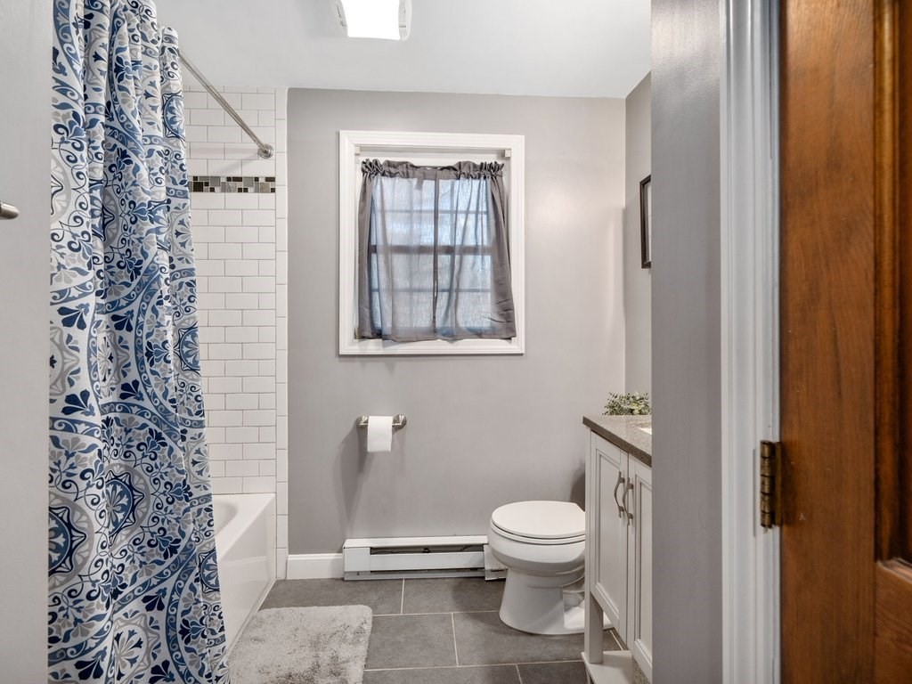 62 Middle Road Amesbury, MA 01913 - Photo 8 of 24 a white toilet sitting next to a bathroom sink