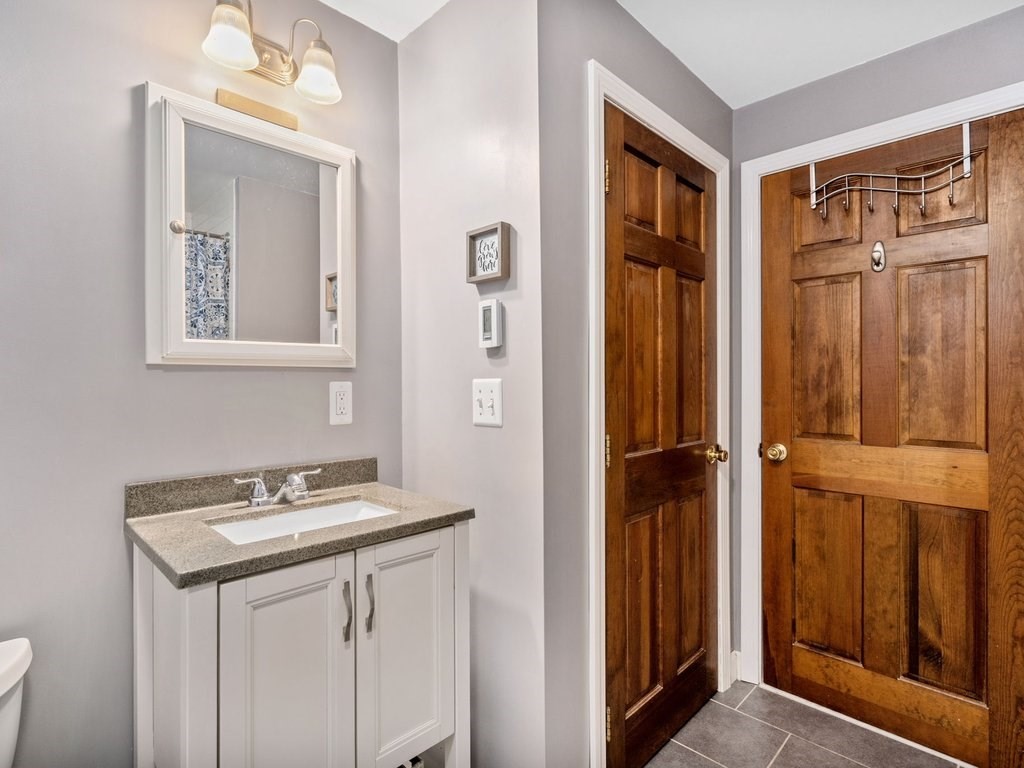 62 Middle Road Amesbury, MA 01913 - Photo 9 of 24 a bathroom with a sink a mirror and a shower