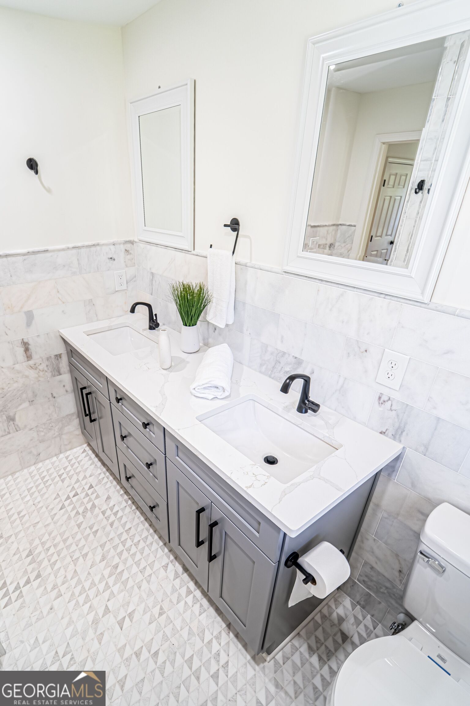 5205 Corinth Circle, Unit 3 Stone Mountain, GA 30087 - Photo 15 of 22 a spacious bathroom with a double vanity sink mirror and toilet