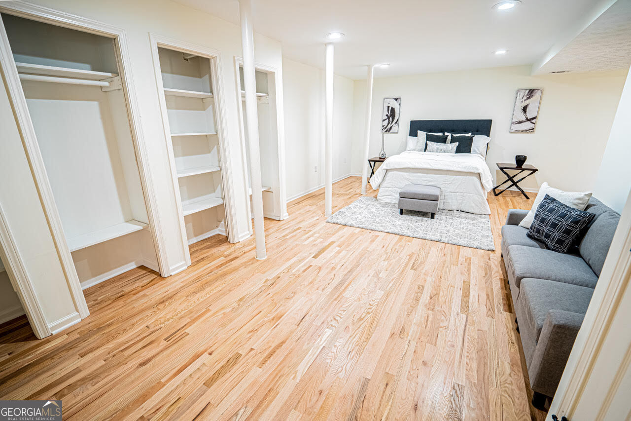 5205 Corinth Circle, Unit 3 Stone Mountain, GA 30087 - Photo 18 of 22 a spacious bedroom with a bed and a wooden floor