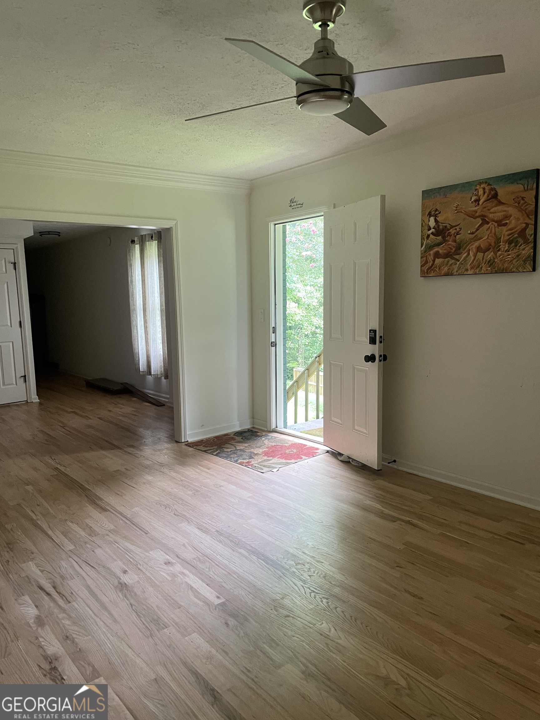 5205 Corinth Circle, Unit 3 Stone Mountain, GA 30087 - Photo 2 of 22 a view of an empty room with window and wooden floor