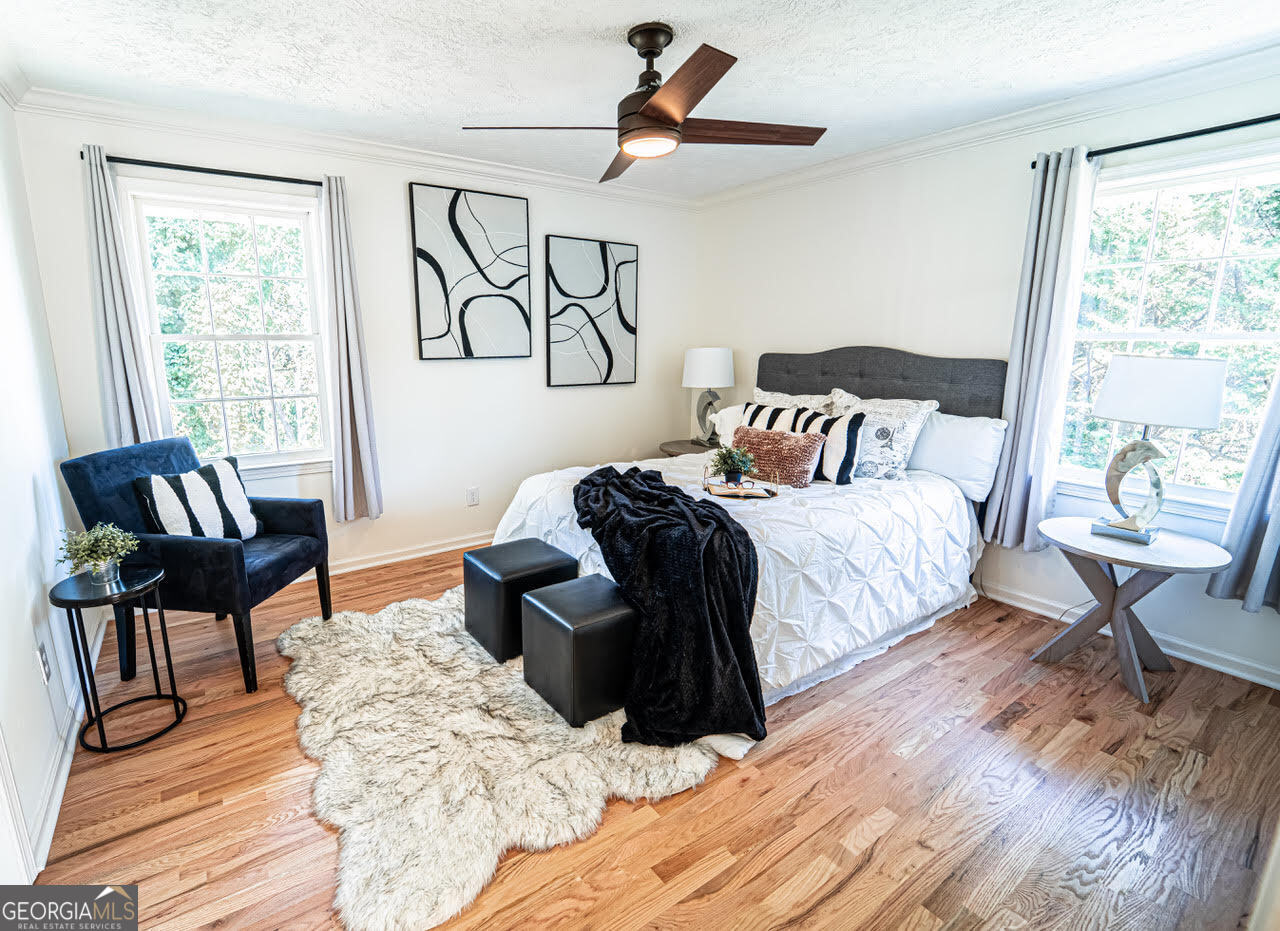 5205 Corinth Circle, Unit 3 Stone Mountain, GA 30087 - Photo 7 of 22 a bedroom with a bed and wooden floor