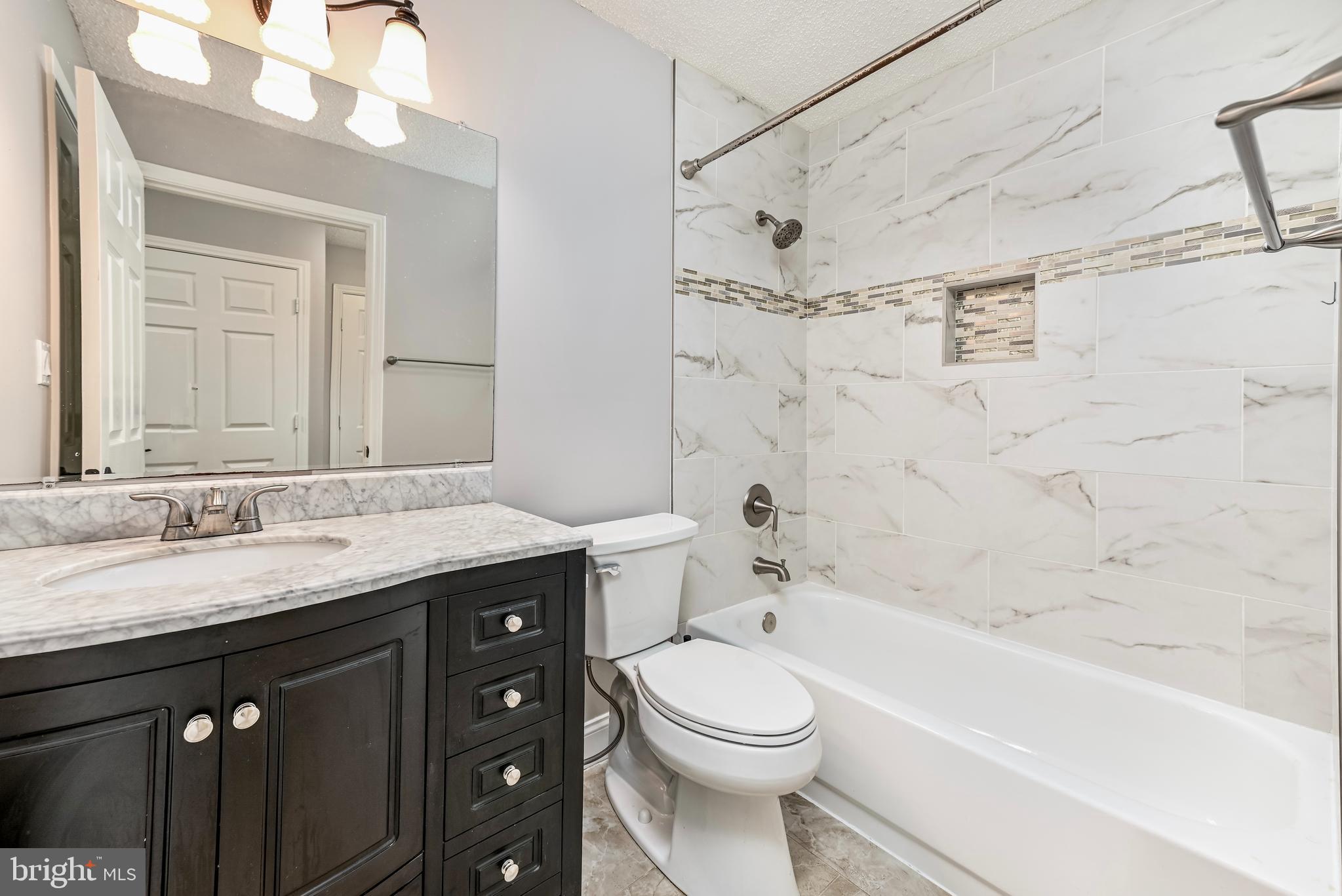 20991 Timber Ridge Terrace, Unit 204 Ashburn, VA 20147 - Photo 16 of 27 Master Bath with granite counter and Tile