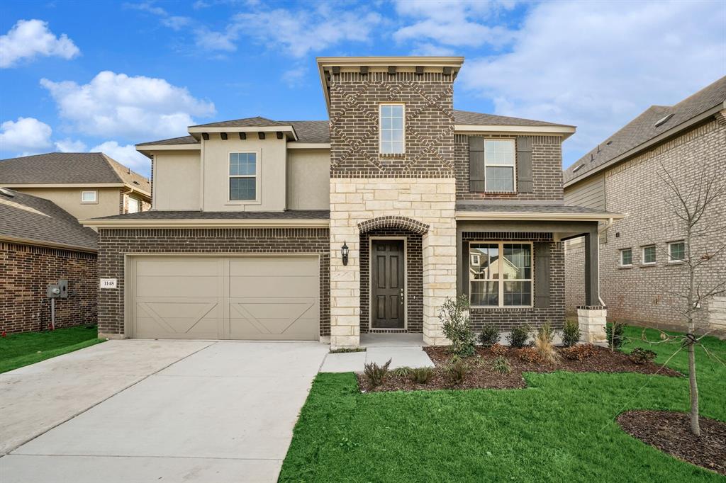 1148 Firecracker Drive Justin, TX 76247 - Photo 1 of 1 a front view of a house with a yard and garage
