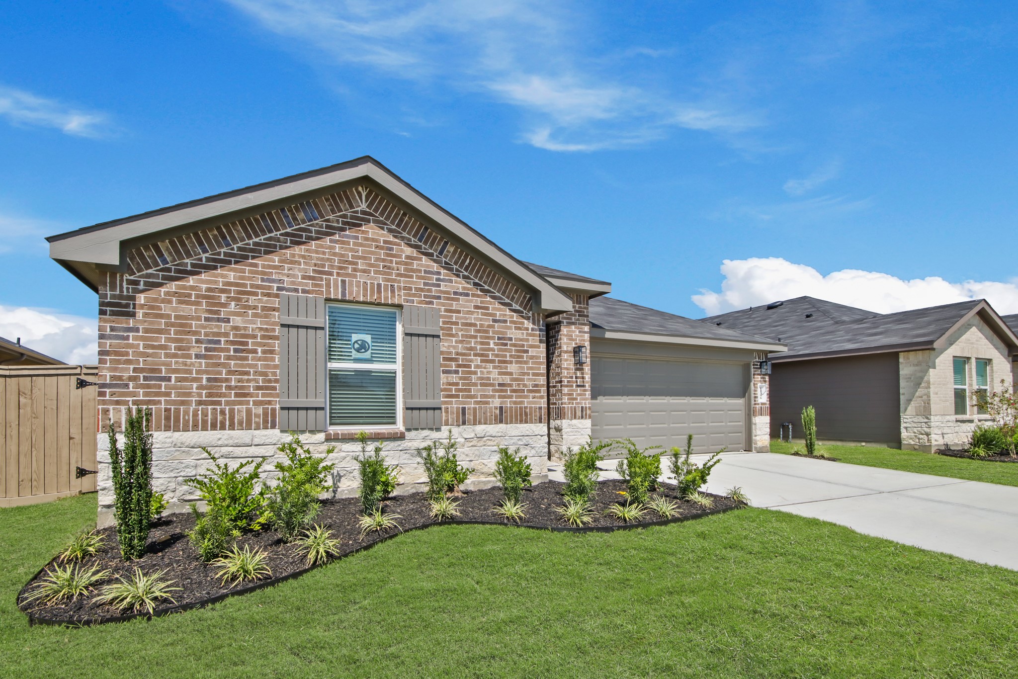 14396 Oceanblue Way Splendora, TX 77372 - Photo 2 of 24 a front view of a house with a garden and plants