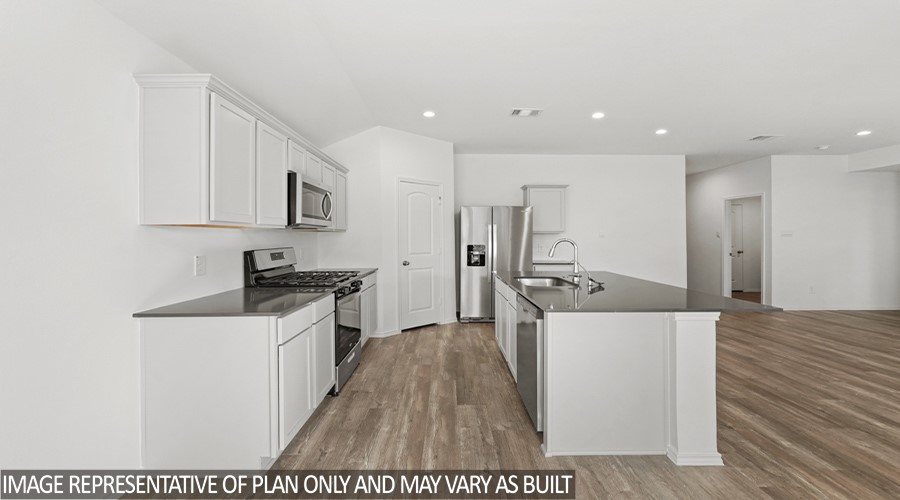 14396 Oceanblue Way Splendora, TX 77372 - Photo 5 of 24 a kitchen with stainless steel appliances a stove a sink a refrigerator and cabinets