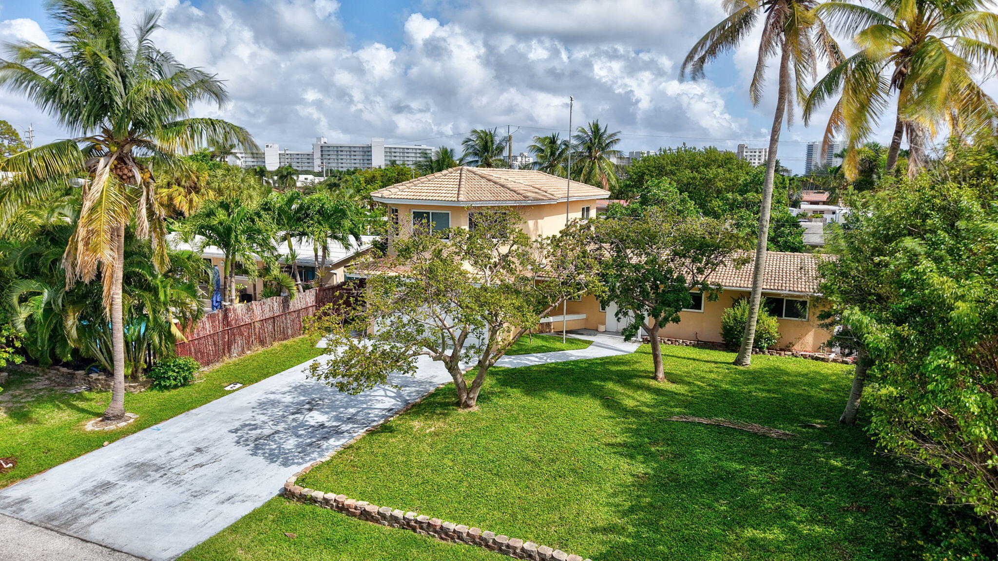1300 Northeast 26th Avenue Pompano Beach, FL 33062 - Photo 20 of 68 a view of a garden with a table under an umbrella