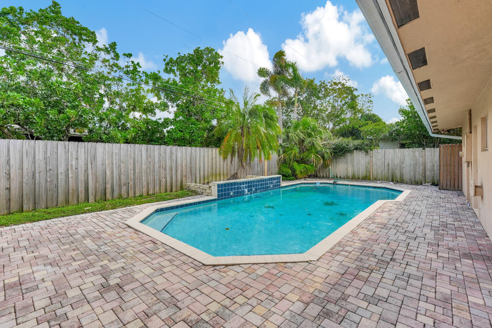 1300 Northeast 26th Avenue Pompano Beach, FL 33062 - Photo 24 of 68 a view of a backyard with large tree and wooden fence