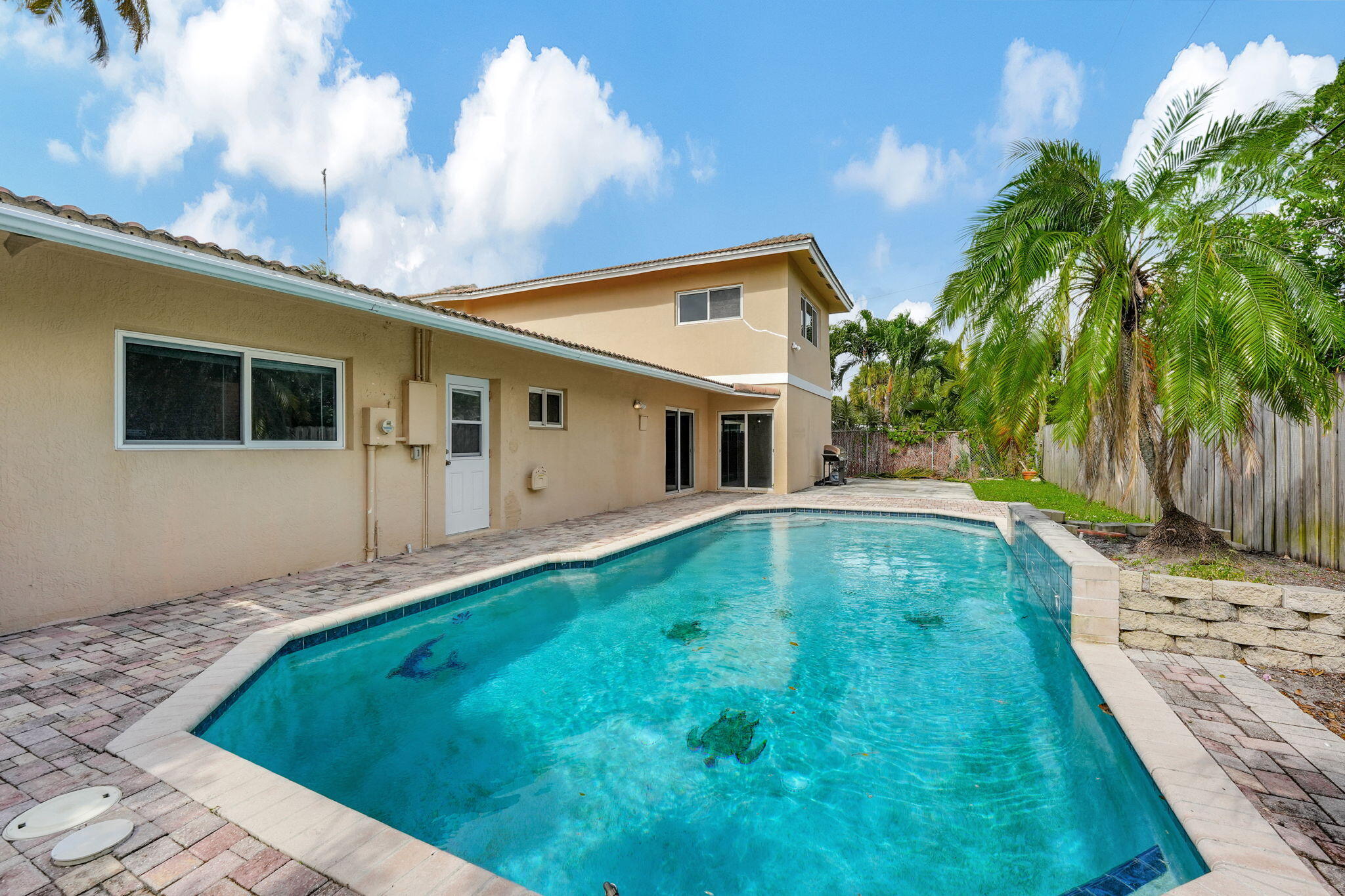 1300 Northeast 26th Avenue Pompano Beach, FL 33062 - Photo 3 of 68 a backyard of a house with table and chairs