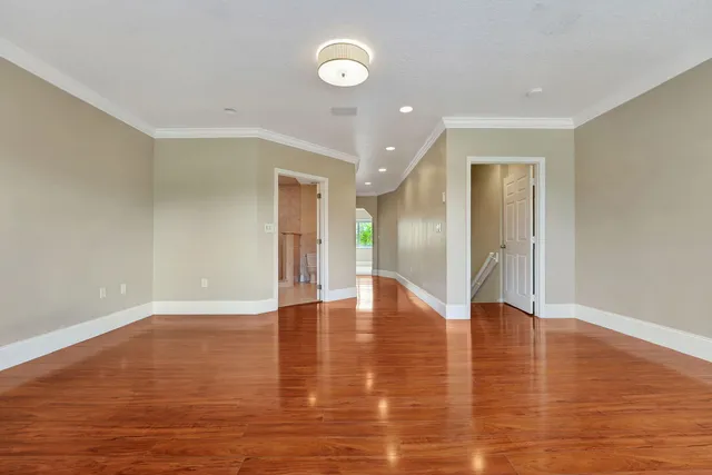 a view of a room with wooden floor and windows