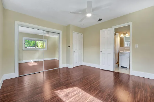 a kitchen with granite countertop a sink and a refrigerator