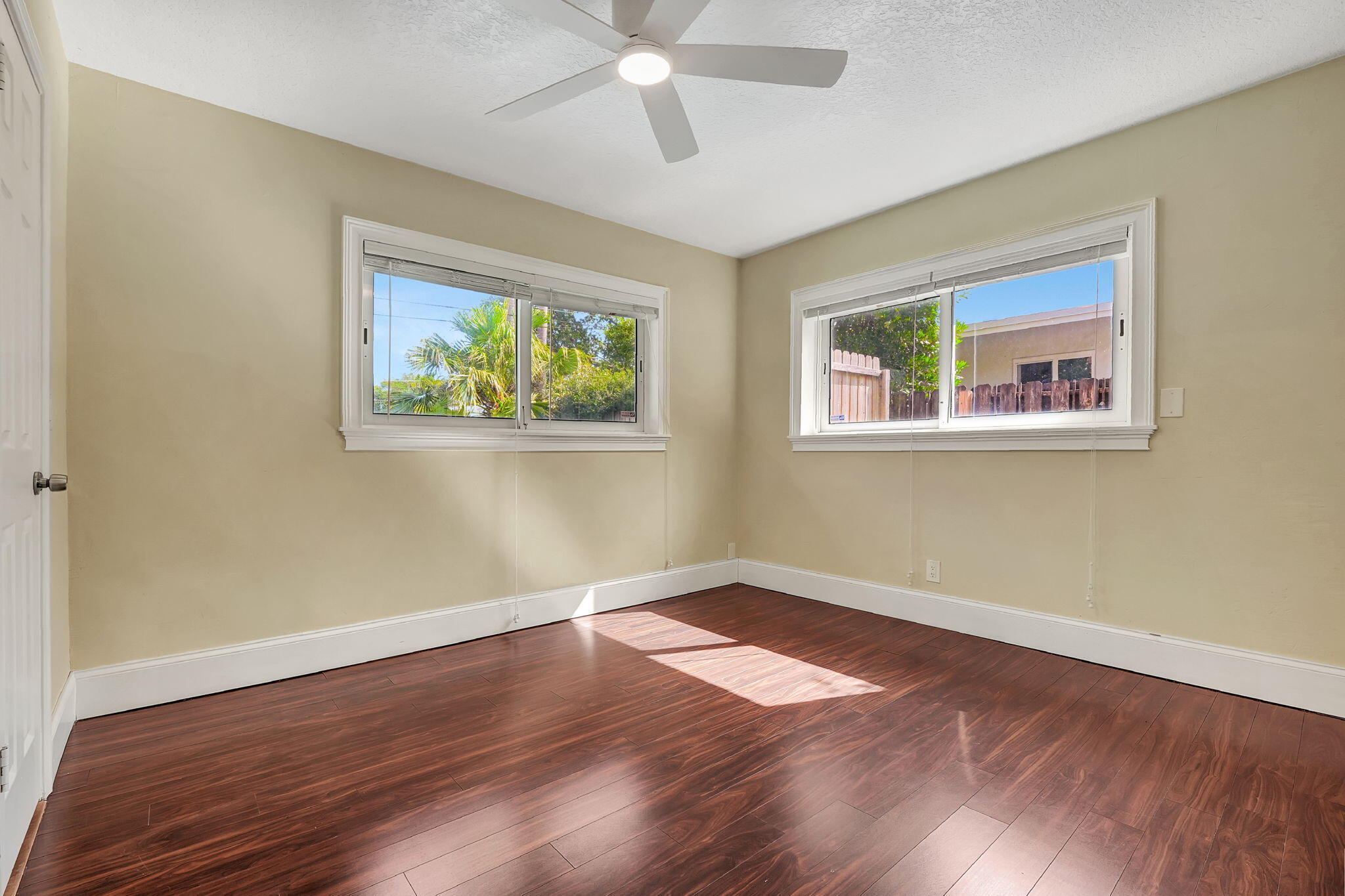 1300 Northeast 26th Avenue Pompano Beach, FL 33062 - Photo 40 of 68 a view of an empty room with wooden floor and a window