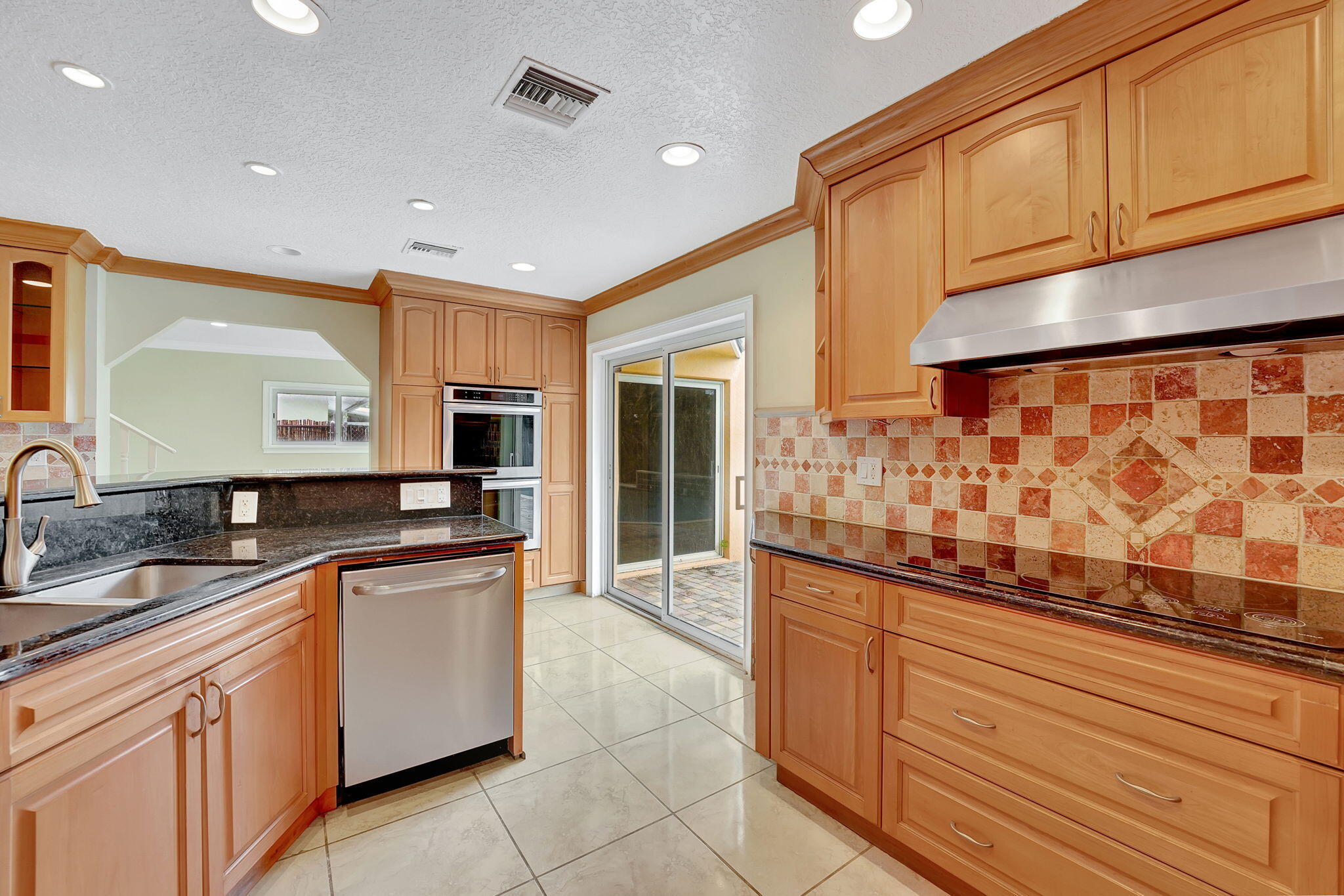 1300 Northeast 26th Avenue Pompano Beach, FL 33062 - Photo 58 of 68 a kitchen with stainless steel appliances granite countertop a sink and cabinets